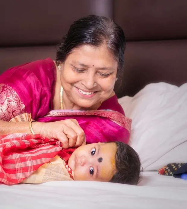 A grandmother smiling at her grandchild